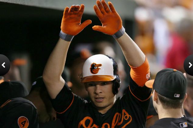 Danny Valencia celebrates in the dugout after his 3rd-inning home run (Rob Carr/Getty Images via MLB.com)